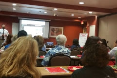 Kianor Shah speaking at a conference